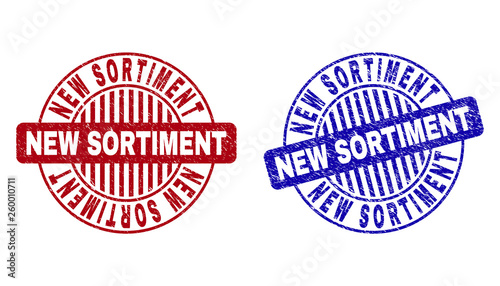 Grunge NEW SORTIMENT round stamp seals isolated on a white background. Round seals with grunge texture in red and blue colors.