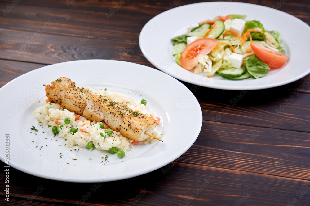 chicken kebab with rice and vegetables on the wooden background chicken kebab with rice and vegetables on the wooden background