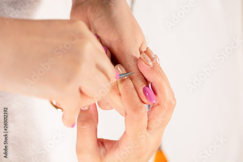 Closeup view of hands with manicure of young woman Nail treatment by a specialist in the salon