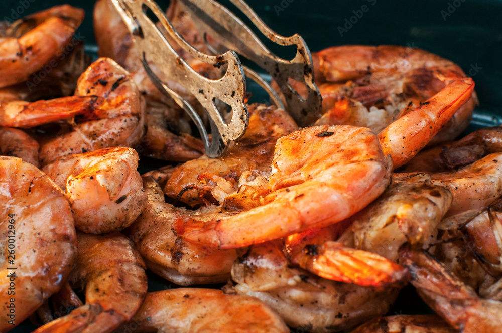 Spicy grilled shrimps closeup as food background