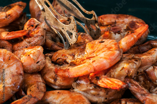 Spicy grilled shrimps closeup as food background