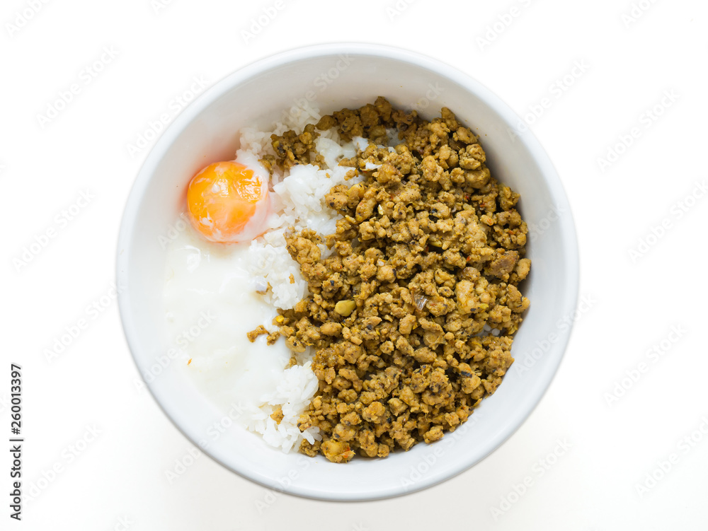 minced pork stir with yellow and Poached egg over steam rice in white bowl minced pork stir with yellow and Poached egg over steam rice in white bowl