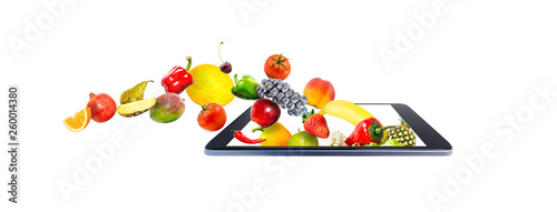 Fototapeta Naklejka Na Ścianę i Meble -  Fresh vegetables and fruits, flying, falling, into a shopping cart in a modern gadget, mobile phone, isolated on a white background. Creative idea online shopping.