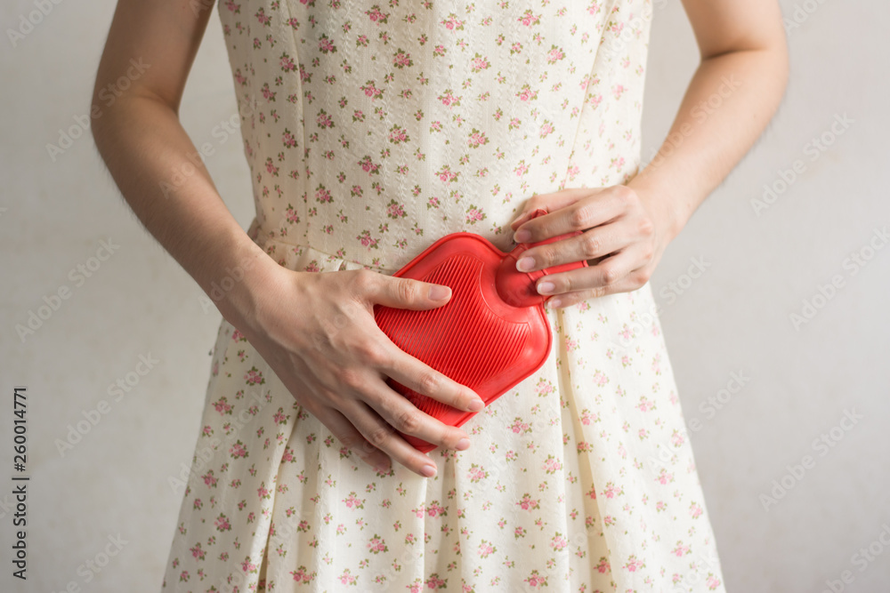 Close up woman has abdominal pain, woman's belly with hot water bottle,Close up woman use Hot Pack Close up woman has abdominal pain, woman's belly with hot water bottle,Close up woman use Hot Pack