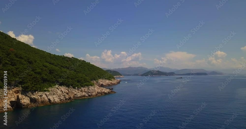 Bright, sunny scene in Dubrovnik, Croatia. Landscape with sea, hills and distant boat, shot by drone Bright, sunny scene in Dubrovnik, Croatia. Landscape with sea, hills and distant boat, shot by drone
