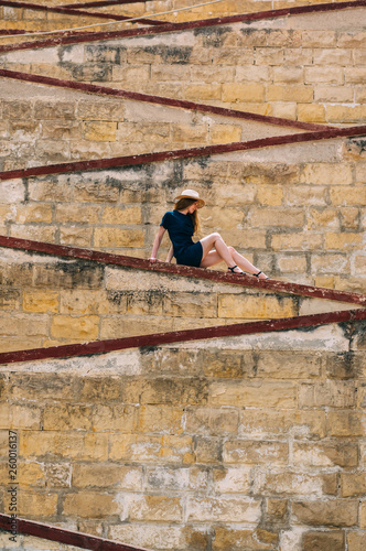 Young girl sitting on the city walls, old city of the Threee Cities photo