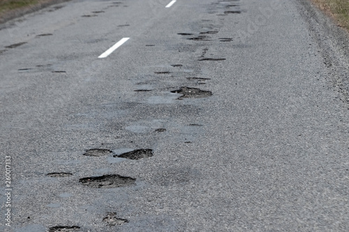 Фотография The road in disrepair with a lot of potholes