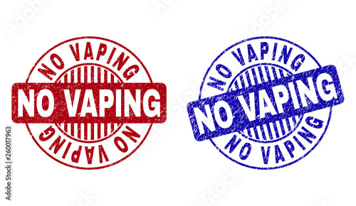 Grunge NO VAPING round stamp seals isolated on a white background. Round seals with grunge texture in red and blue colors. Vector rubber overlay of NO VAPING caption inside circle form with stripes.
