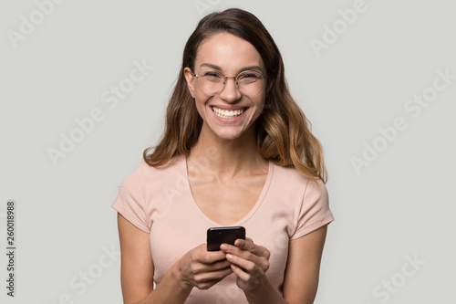 Headshot portrait laughing girl in glasses looking at camera