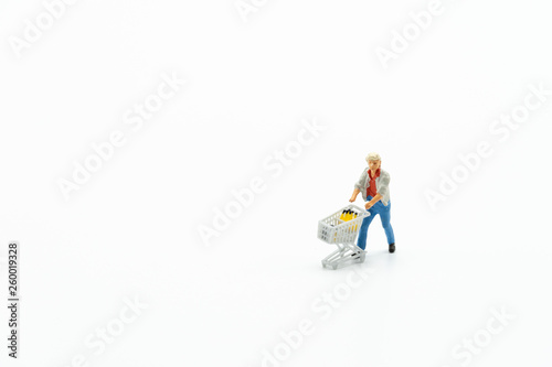 Miniature people, customer with shopping cart isolated on white background. Concept of money saving, financial,and marketing.