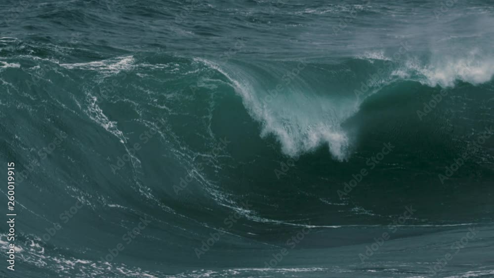 Large wave gurgles along a shallow reef break in Australia. Wide shot playing in slow motion. Large wave gurgles along a shallow reef break in Australia. Wide shot playing in slow motion.