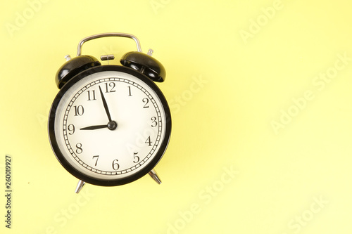 Time Punctuality Concept with black alarm clock.