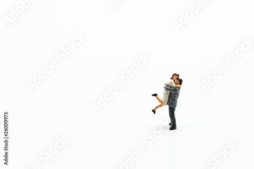 Miniature people, family and children isolated on white background. International Day of Families