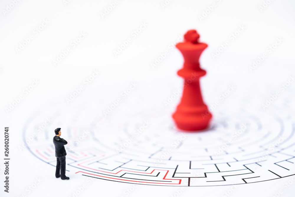 Miniature people, businessman and chess pieces in the labyrinth or maze figuring out the way out. Business concept, finding solution, strategic, and business opportunity. Miniature people, businessman and chess pieces in the labyrinth or maze figuring out the way out. Business concept, finding solution, strategic, and business opportunity.