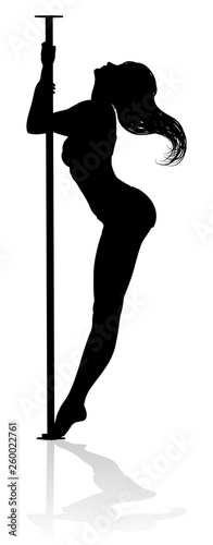 A woman pole dancer exercising for fitness in silhouette