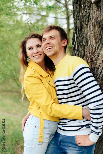 young couple in love in yellow clothes on nature against the background of a tree 1 © ShevarevAlex