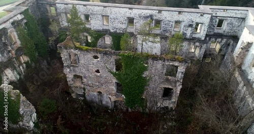 Drone aerial view with left side pan of a castle ruined during WW2 by resistance fighters. photo