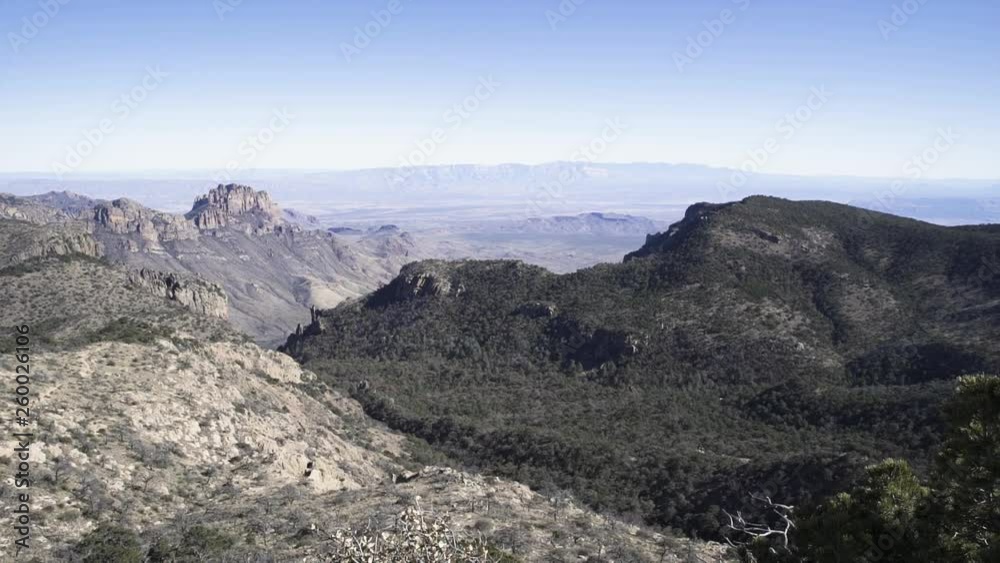 Pan right wide shot sunny daytime of mountains and pine forest in Texas Pan right wide shot sunny daytime of mountains and pine forest in Texas