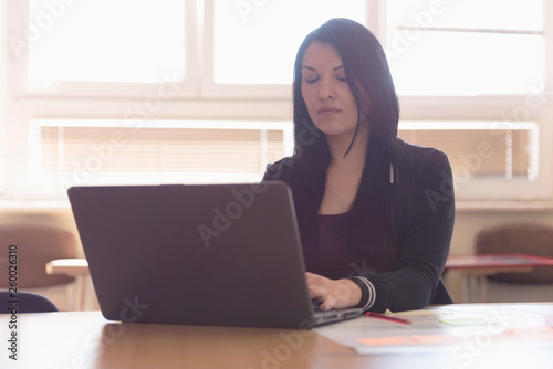 Young female talented designer looking at innovative project suggesting creative solution to client using digital networks  brainstorming for ideas. Looking at innovative project.