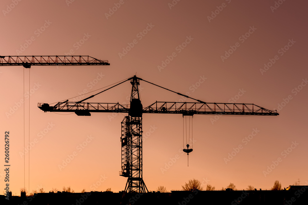 crane silhouette at sunset, urban view