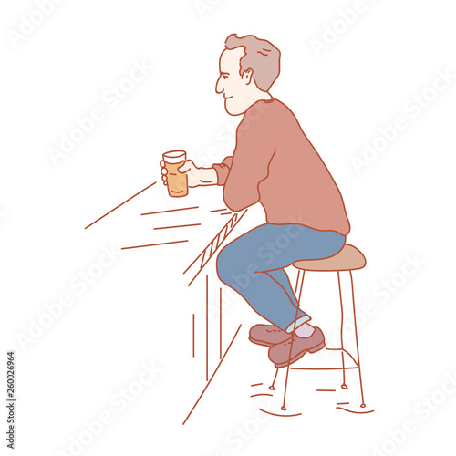 Pub vistor sitting with a pint of beer in his hand