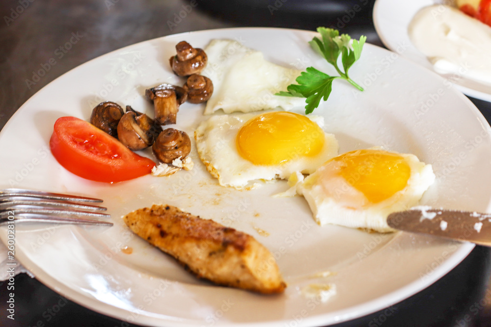 Breakfast of plate with fried eggs and vegetables, mushrooms Breakfast of plate with fried eggs and vegetables, mushrooms