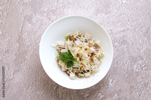 Salad with chicken meat, walnuts, cheese and chinese cabbage