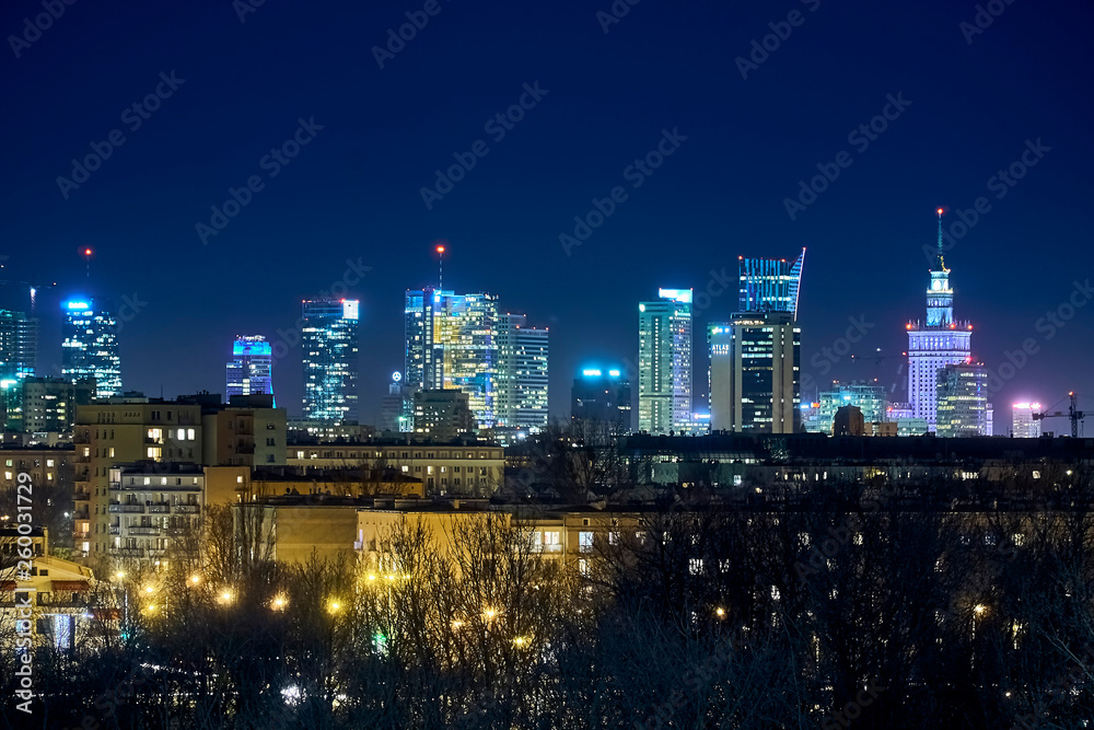 Obraz premium Beautiful, amazing panoramic view of Warsaw (Poland) with skyscrapers and a Palace of Culture and Science during spring flowering at night