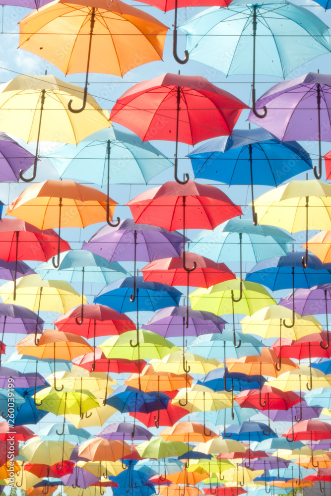 Multi-colored umbrellas against the sky