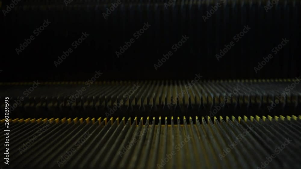 Escalator. Moving staircase in business center. Laziness. Moving steps with yellow stripes. Ascent and descent. Underground. Motor driven chain Escalator. Moving staircase in business center. Laziness. Moving steps with yellow stripes. Ascent and descent. Underground. Motor driven chain