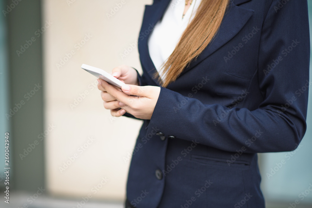 The business lady uses a smartphone on the street The business lady uses a smartphone on the street