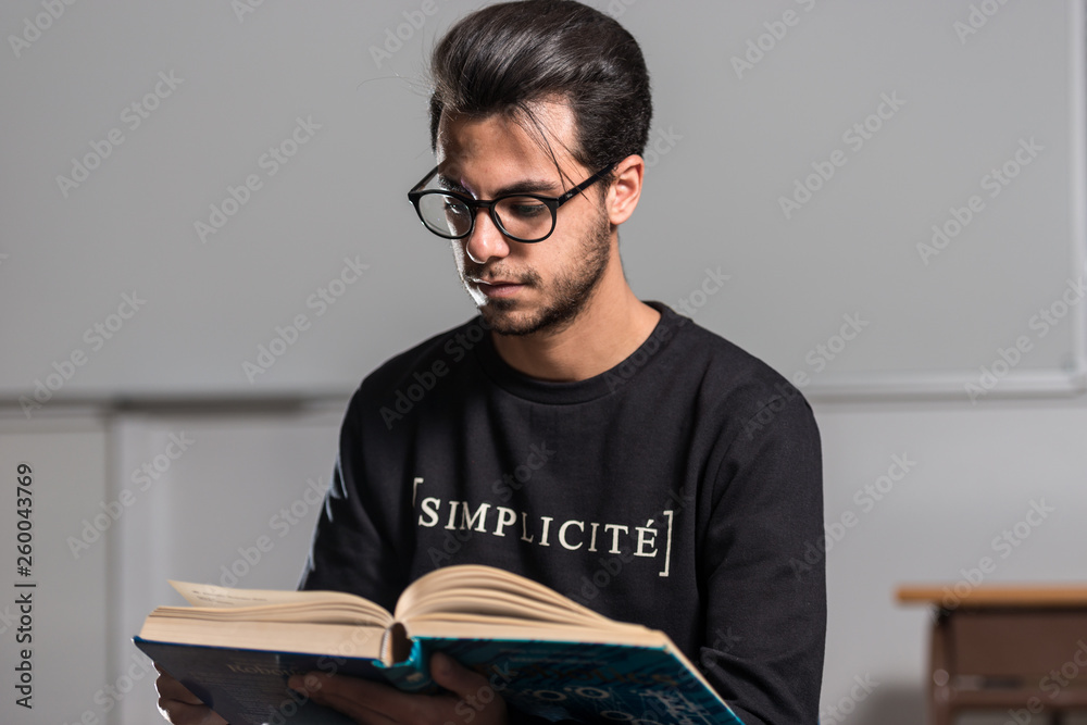 Young computer science student reads an advanced robotics book in Caceres, Spain. Young computer science student reads an advanced robotics book in Caceres, Spain.