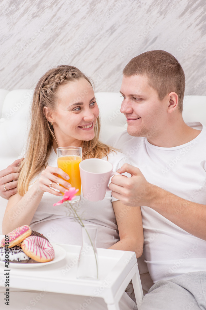 Romantic happy couple having breakfast on the bed Romantic happy couple having breakfast on the bed