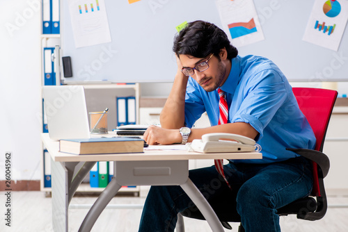 Young male financial manager working in the office 