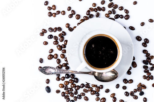 Cup with coffee beans on white background