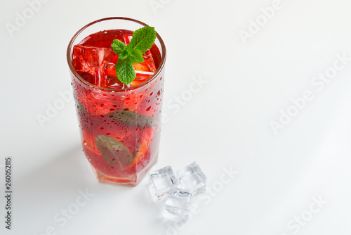 Red fresh drink with ice, grapefruit and mint isolated on white. Space for text or design.