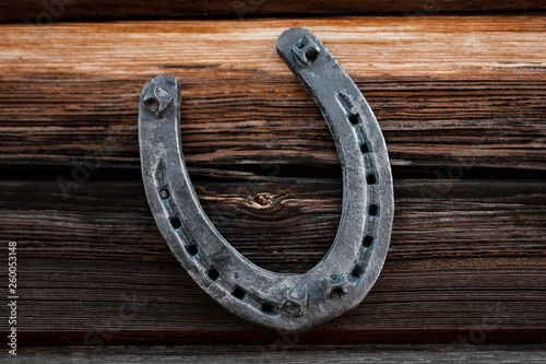 Old horseshoe on an old wooden board. The concept of luck, luck, luck.