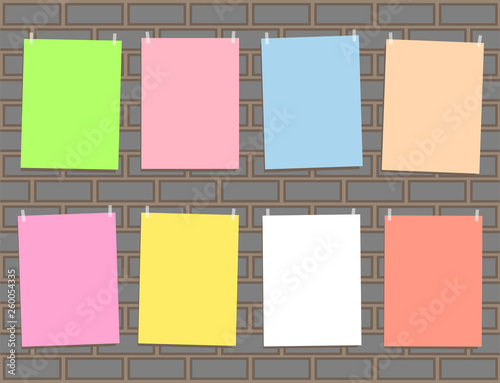 Eight multicolored paper for office notes, memos, ads on a gray brick wall mockup design background. photo