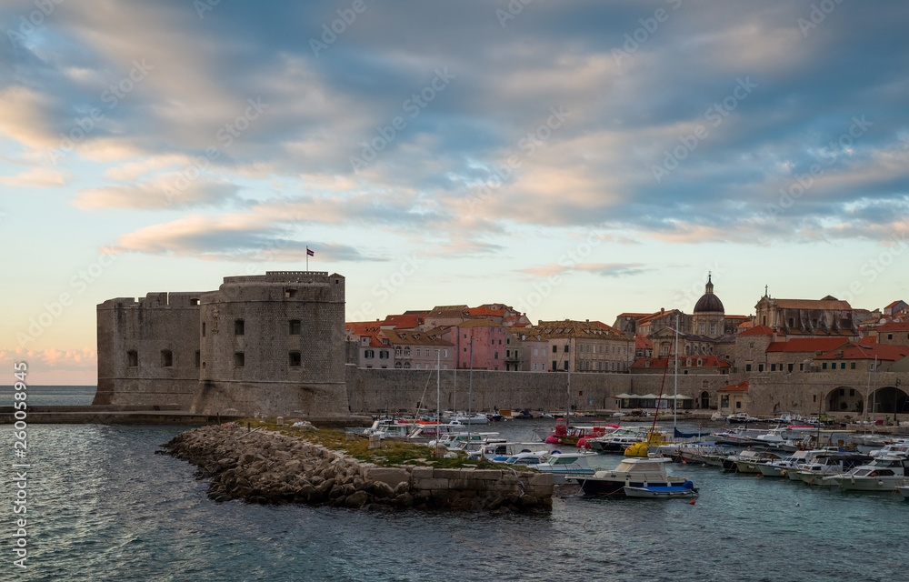 Sunrise in Dubrovnik, a landscape overlooking the old town and large stones in the foreground, Croatia