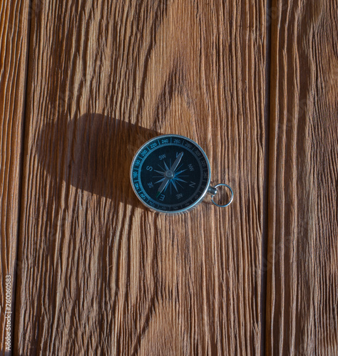 Compass with a rope on the background of the old board