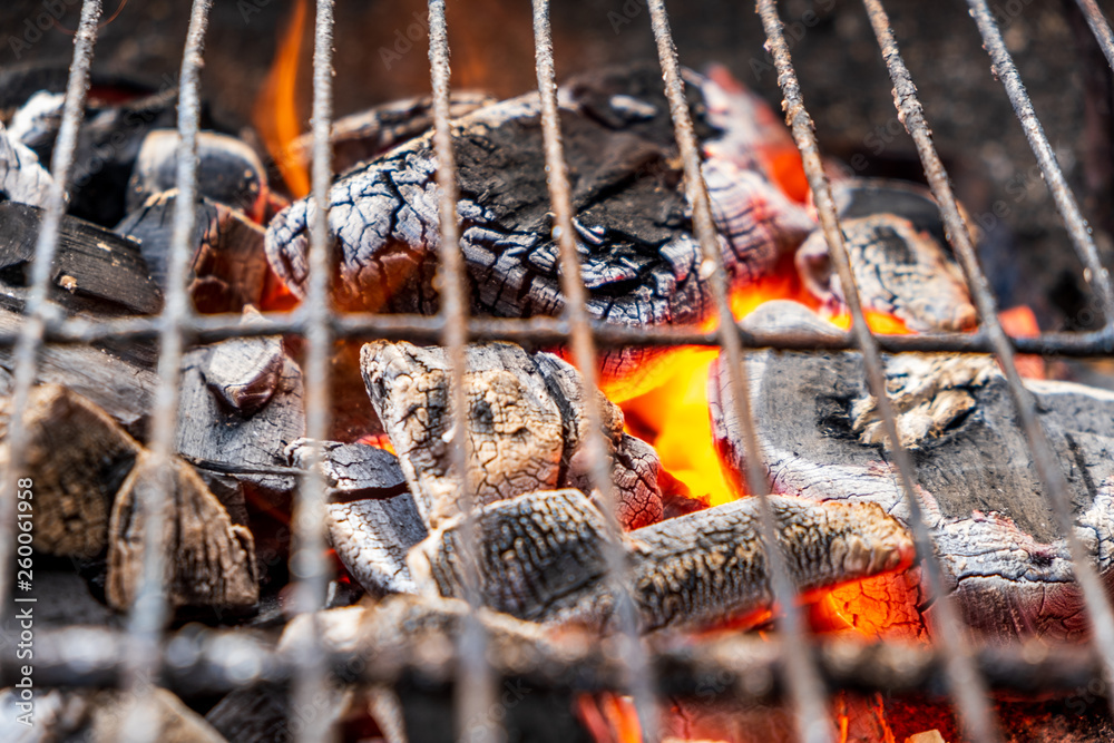 Grill charcoal burning with an open flame isolated 