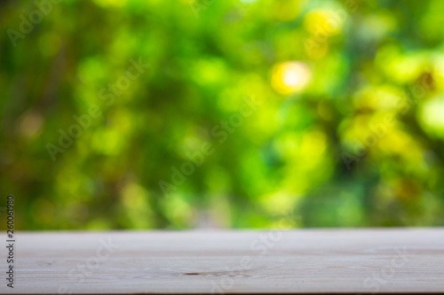 Empty wooden table texture, Green garden blurred bokeh background, Selective focus
