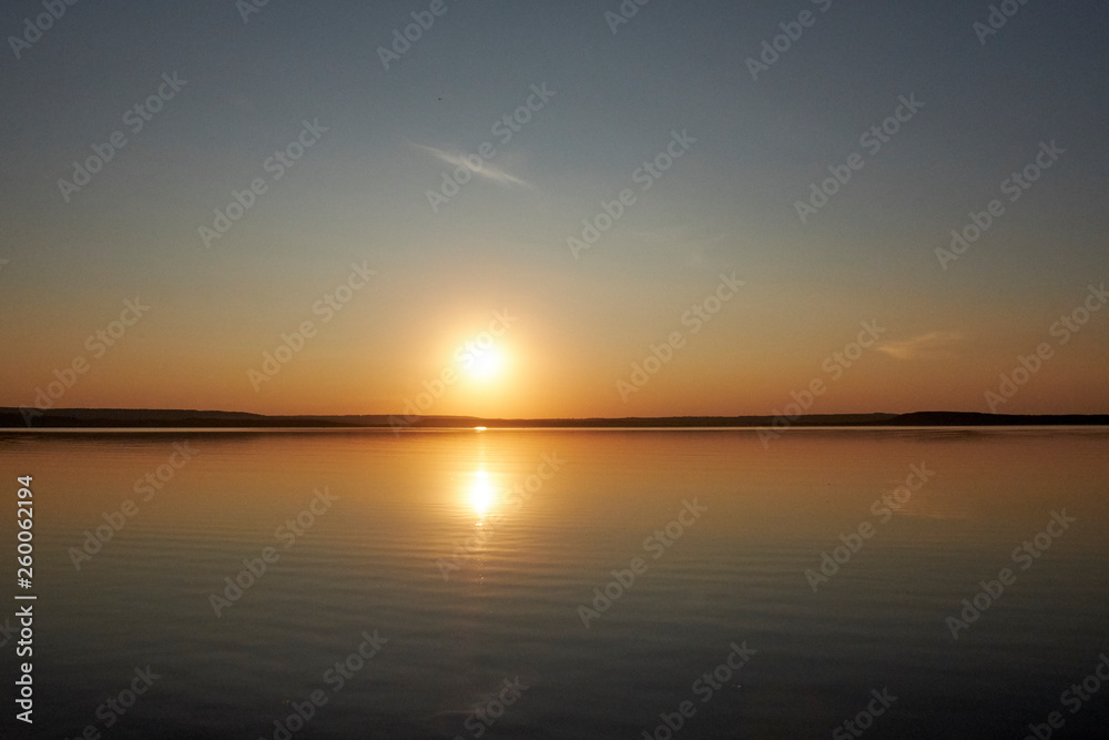 Sunset on the lake without waves