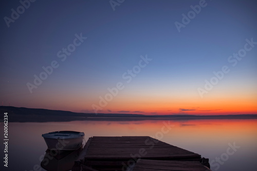 Fishing boat on the pier at sunset © Eduard Vladimirovich