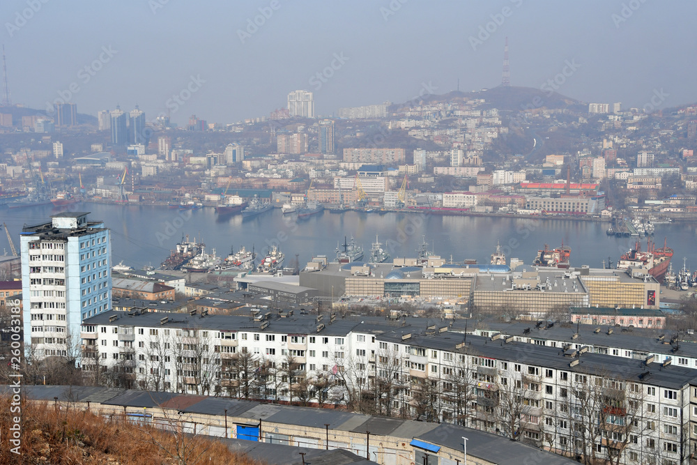 Russia. Winter Vladivostok in a haze. In the foreground street Okatovaya