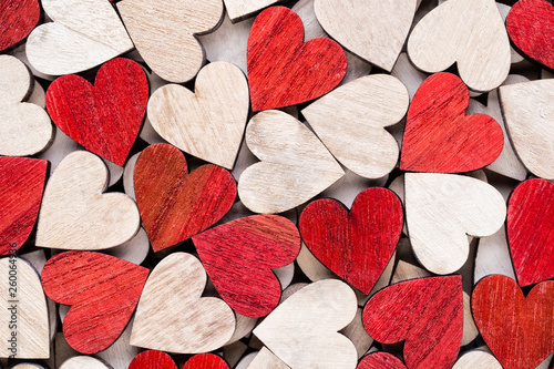 Valentines day background with white end red hearts on wooden background.