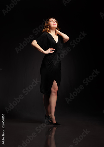 high fashion portrait of elegant woman in long black dress.