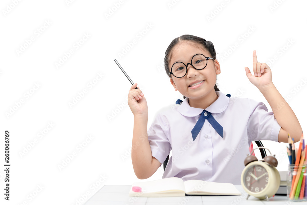Cute asian student doing homework on table isolated