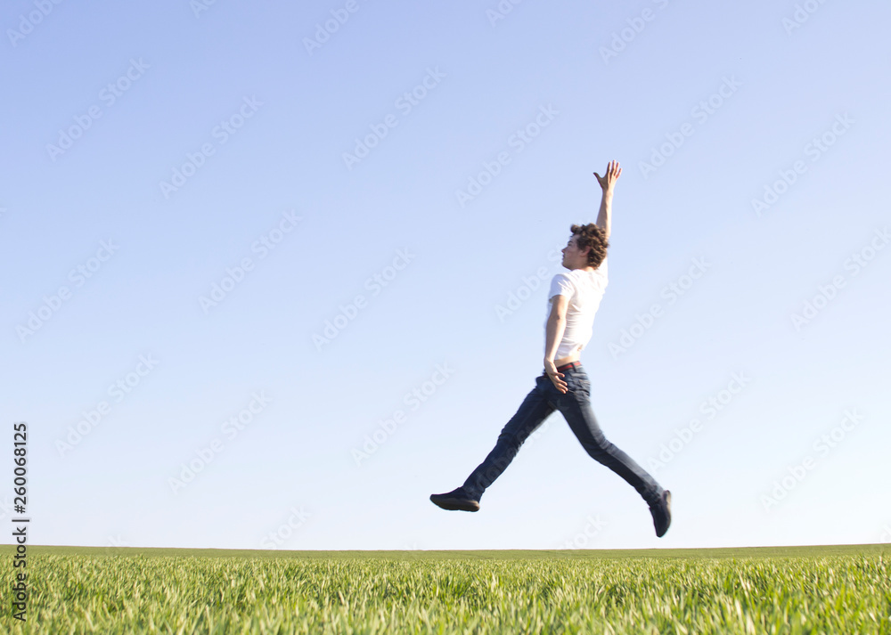 teenager in white t-shirt bouncing high up teenager in white t-shirt bouncing high up
