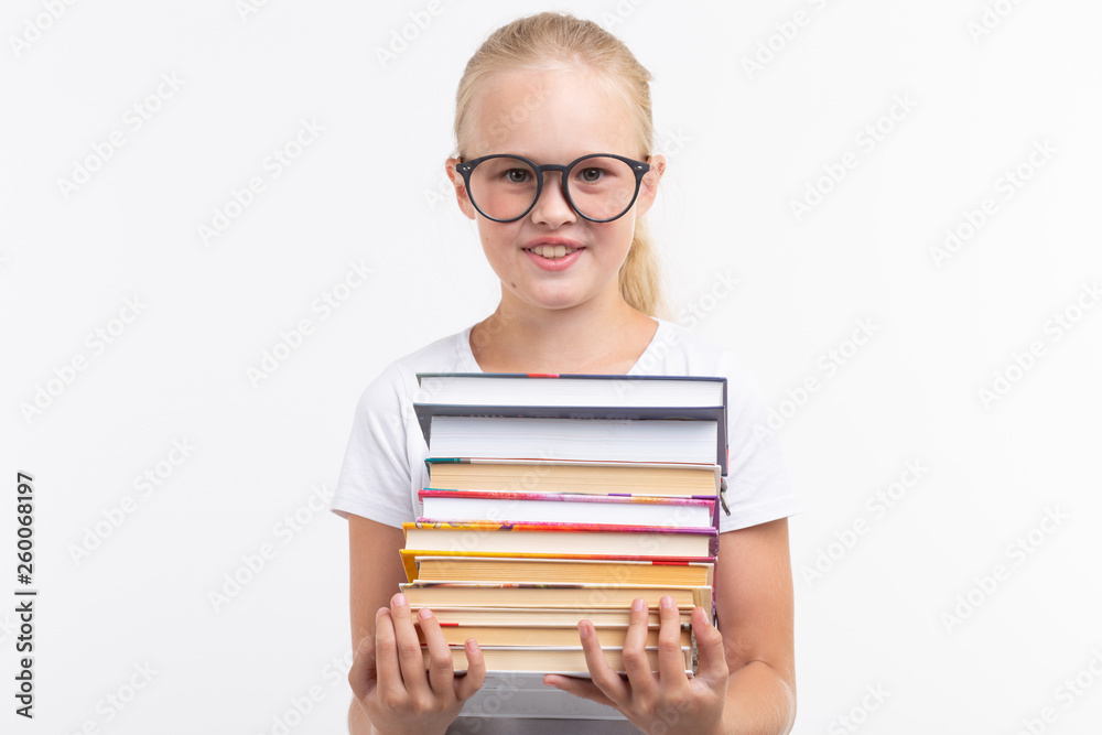 education, people, children and school concept - School student in goggles holding books in hands on white background education, people, children and school concept - School student in goggles holding books in hands on white background